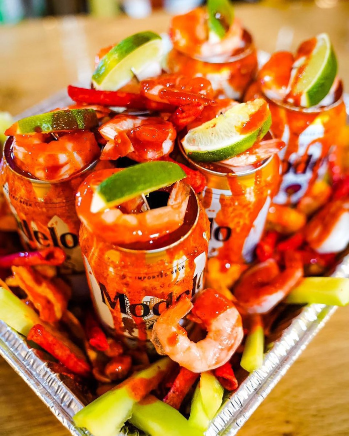 Shrimp cocktail with cucumber, lime, onion, and a chamoy rim
