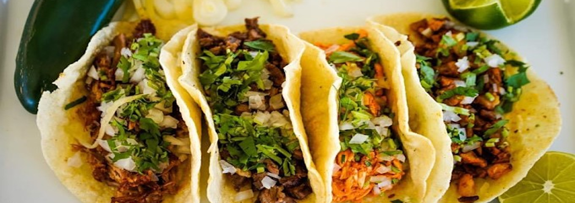Tacos El Sol street tacos with cilantro and onion, served with lime